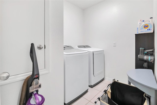 washroom with washer and clothes dryer and light tile patterned floors