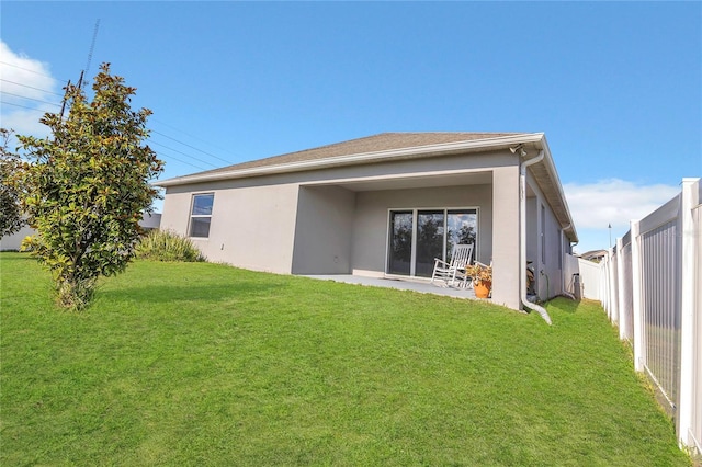 rear view of house with stucco siding and a patio area