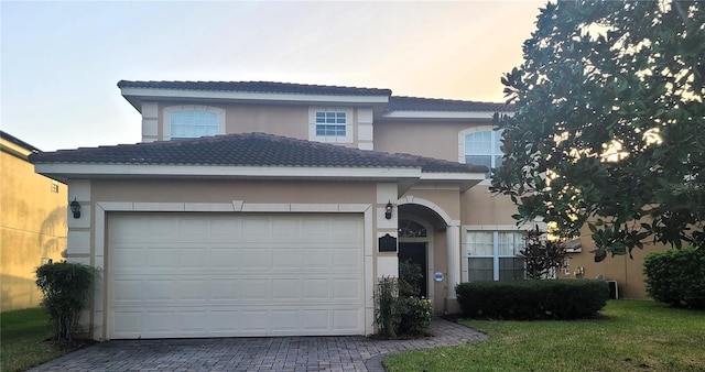 225 Vista Dr, Davenport, FL 33897 - traditional home with stucco siding, decorative driveway, and a garage