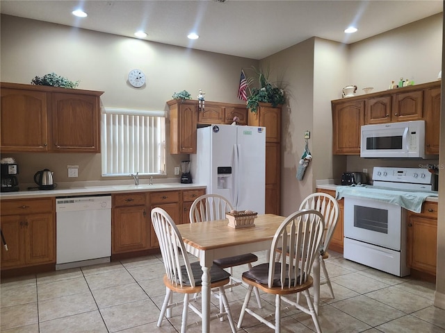 225 Vista Dr, Davenport, FL 33897 - kitchen with white appliances, light countertops, brown cabinetry, and recessed lighting