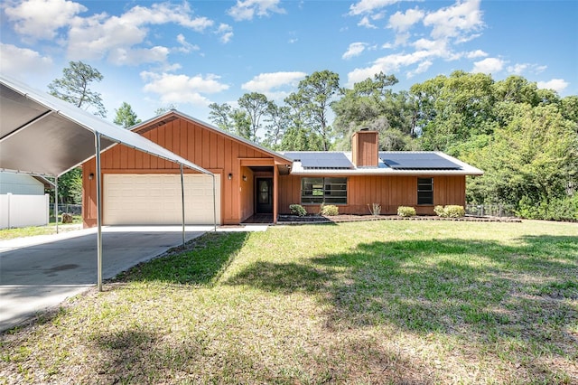 175 Cliff St, Deland, FL 32720 - view of front of house featuring an attached garage, a chimney, concrete driveway, solar panels, and board and batten siding