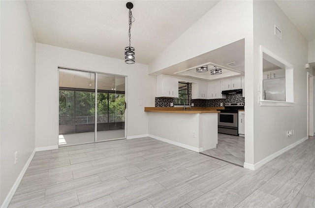 175 Cliff St, Deland, FL 32720 - kitchen with stainless steel electric range oven, white cabinetry, a peninsula, butcher block countertops, and decorative backsplash