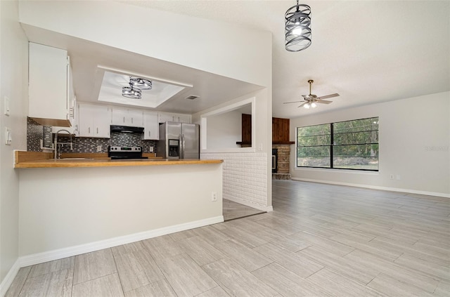 175 Cliff St, Deland, FL 32720 - kitchen featuring appliances with stainless steel finishes, open floor plan, wooden counters, a ceiling fan, and under cabinet range hood