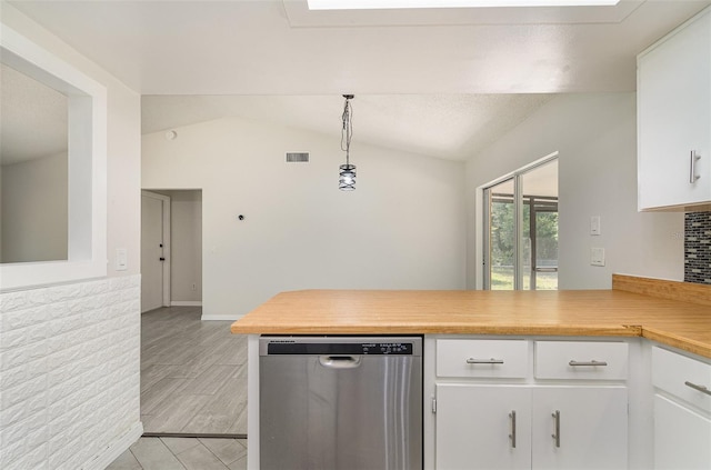 175 Cliff St, Deland, FL 32720 - kitchen featuring dishwasher, light countertops, lofted ceiling, white cabinetry, and a peninsula