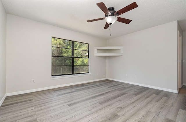 175 Cliff St, Deland, FL 32720 - spare room with wood finished floors, a ceiling fan, baseboards, and a textured ceiling
