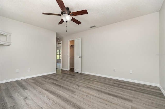175 Cliff St, Deland, FL 32720 - unfurnished room featuring wood finished floors, ceiling fan, a textured ceiling, and baseboards