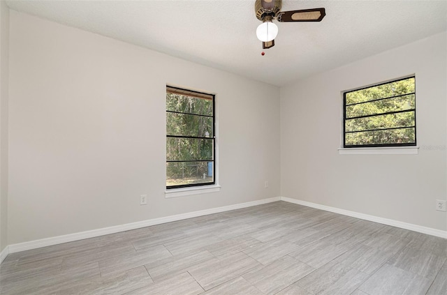 175 Cliff St, Deland, FL 32720 - spare room featuring healthy amount of natural light, ceiling fan, light wood-style floors, and baseboards