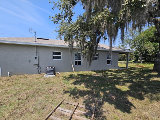 141 W G H Washington St, Apopka, FL 32703 - rear view of property with stucco siding and a lawn