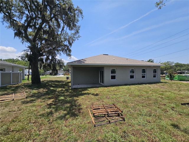 141 W G H Washington St, Apopka, FL 32703 - rear view of house with stucco siding and a lawn