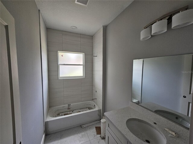 141 W G H Washington St, Apopka, FL 32703 - full bath with vanity, shower / bathtub combination, and a textured ceiling