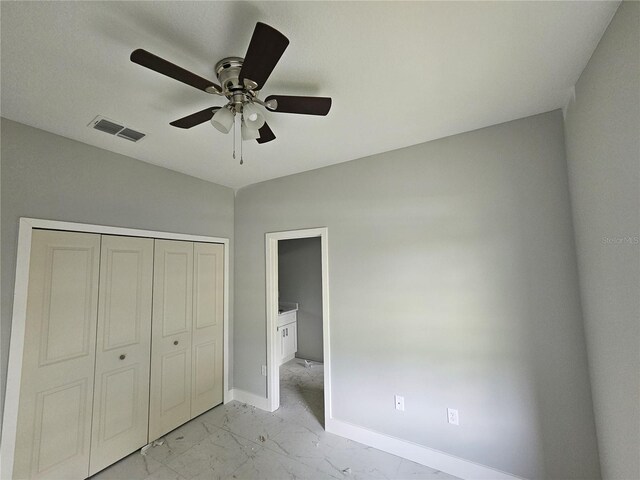 141 W G H Washington St, Apopka, FL 32703 - unfurnished bedroom with light marble finish floors, baseboards, a closet, and ceiling fan