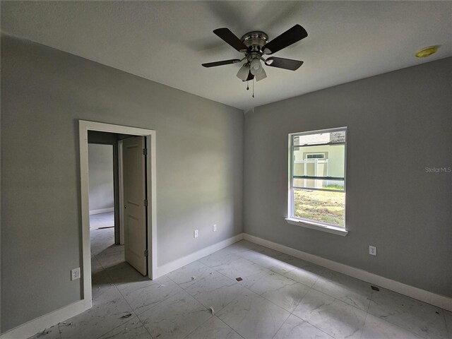 141 W G H Washington St, Apopka, FL 32703 - spare room featuring baseboards, a ceiling fan, and marble look tiles