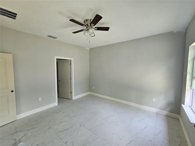 141 W G H Washington St, Apopka, FL 32703 - unfurnished room with light marble finish flooring, baseboards, and ceiling fan