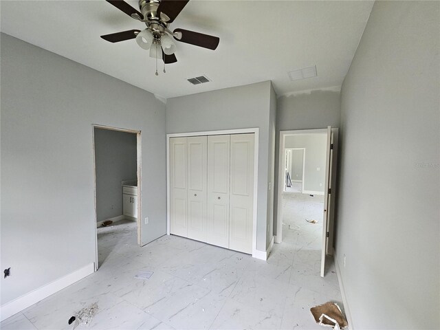 141 W G H Washington St, Apopka, FL 32703 - unfurnished bedroom with a closet, a ceiling fan, light marble finish floors, and baseboards