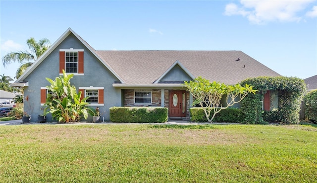 view of front of home featuring a front lawn, stucco siding, stone siding, and a shingled roof