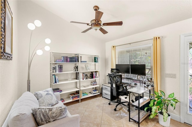 office space with a ceiling fan, vaulted ceiling, and tile patterned flooring