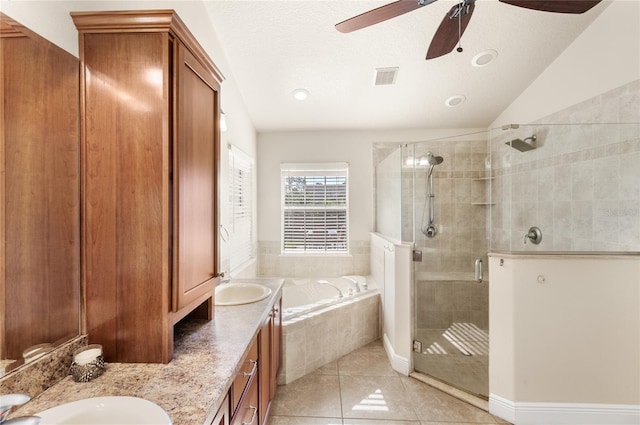 full bathroom with ceiling fan, a shower stall, a bath, double vanity, and tile patterned flooring