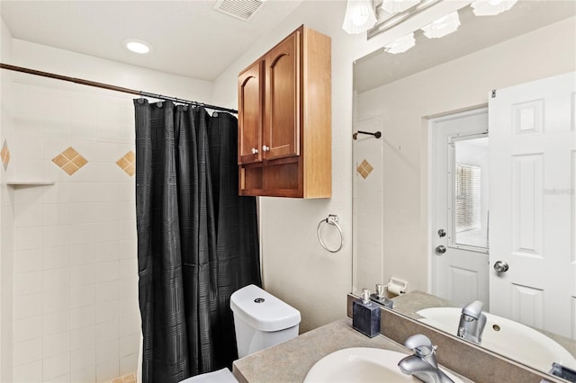 bathroom with a shower with shower curtain, vanity, and toilet