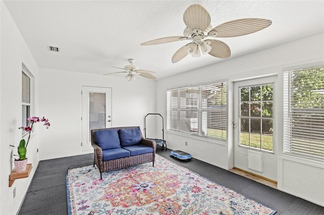 living area featuring ceiling fan