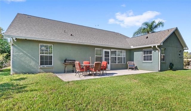 back of house featuring stucco siding, a patio area, and a yard