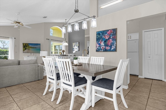 217 Holborn Loop, Davenport, FL 33897 - dining room featuring light tile patterned floors, ceiling fan, and a towering ceiling