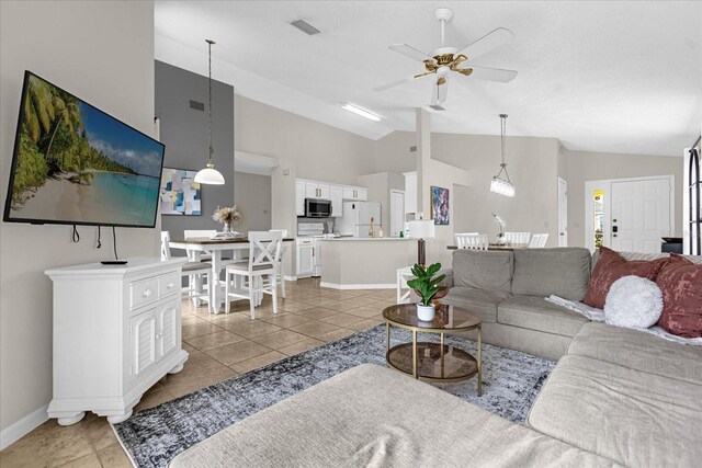 217 Holborn Loop, Davenport, FL 33897 - living area featuring ceiling fan, light tile patterned flooring, baseboards, and high vaulted ceiling