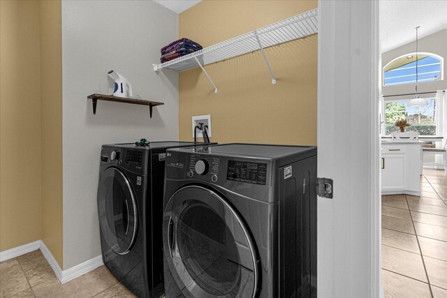 217 Holborn Loop, Davenport, FL 33897 - laundry room with independent washer and dryer, light tile patterned floors, and baseboards