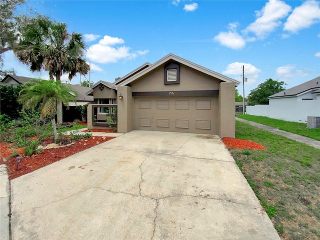 721 Rock Creek Loop, Longwood, FL 32750 - view of front of house featuring stucco siding, driveway, an attached garage, a front lawn, and central air condition unit