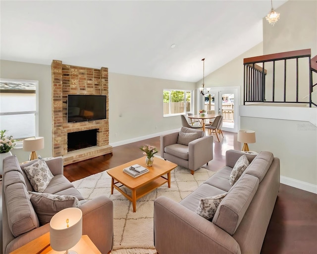 721 Rock Creek Loop, Longwood, FL 32750 - living room with a chandelier, baseboards, wood finished floors, high vaulted ceiling, and a brick fireplace
