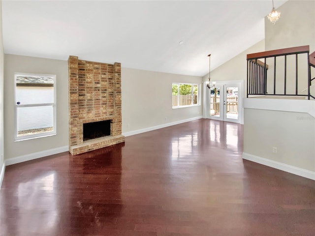 721 Rock Creek Loop, Longwood, FL 32750 - unfurnished living room with a chandelier, dark wood-style flooring, baseboards, a fireplace, and high vaulted ceiling