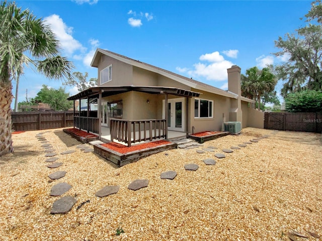 721 Rock Creek Loop, Longwood, FL 32750 - rear view of property featuring stucco siding, a fenced backyard, central AC, and a chimney