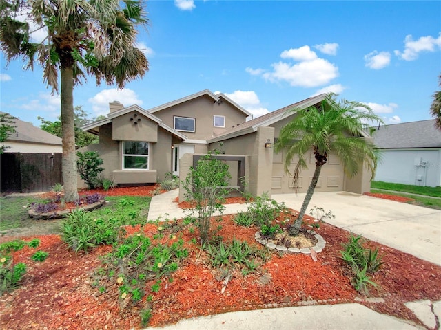721 Rock Creek Loop, Longwood, FL 32750 - view of front of home with stucco siding, concrete driveway, a chimney, a garage, and fence