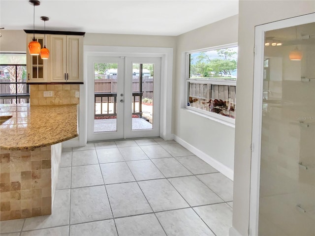 721 Rock Creek Loop, Longwood, FL 32750 - doorway to outside with healthy amount of natural light, french doors, light tile patterned floors, and baseboards