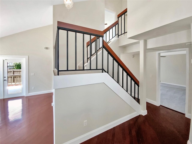 721 Rock Creek Loop, Longwood, FL 32750 - stairs with baseboards, high vaulted ceiling, wood finished floors, and a chandelier
