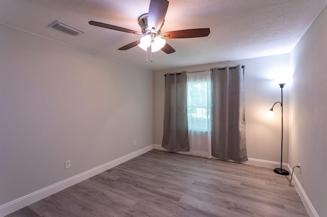 4515 Isaac Ln, Sanford, FL 32771 - empty room with ceiling fan, wood finished floors, baseboards, and a textured ceiling