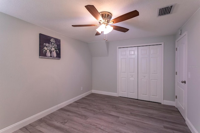 4515 Isaac Ln, Sanford, FL 32771 - unfurnished bedroom with baseboards, wood finished floors, a closet, and ceiling fan