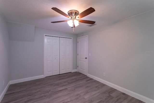 4515 Isaac Ln, Sanford, FL 32771 - unfurnished bedroom with wood finished floors, baseboards, a closet, and ceiling fan