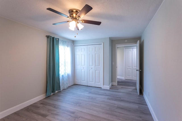 4515 Isaac Ln, Sanford, FL 32771 - unfurnished bedroom with baseboards, wood finished floors, a textured ceiling, a closet, and a ceiling fan