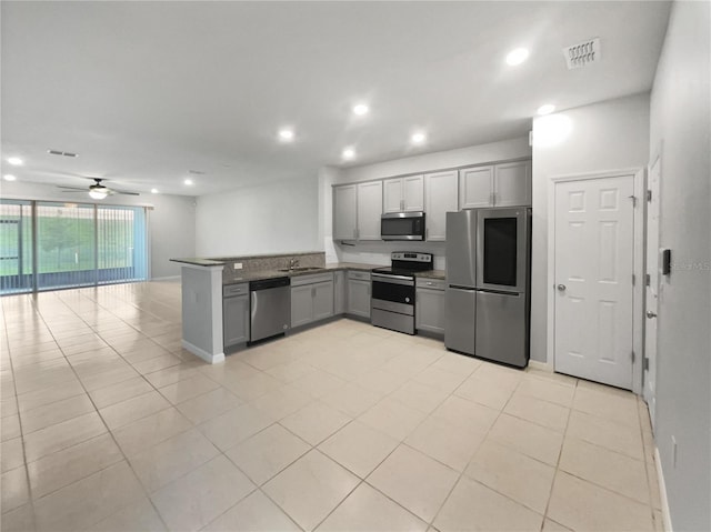 3737 Plainview Dr, Orlando, FL 32824 - kitchen featuring stainless steel appliances, gray cabinetry, open floor plan, a peninsula, and recessed lighting