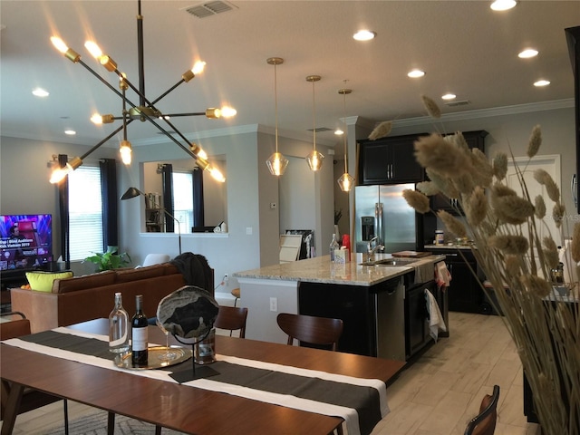 15708 Orange Harvest Loop, Winter Garden, FL 34787 - dining space featuring ornamental molding, recessed lighting, and a chandelier