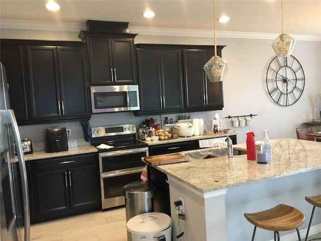 15708 Orange Harvest Loop, Winter Garden, FL 34787 - kitchen with appliances with stainless steel finishes, a sink, a breakfast bar, light stone countertops, and dark cabinets