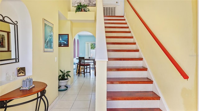 11257 Dacre Ln, Orlando, FL 32824 - stairs featuring arched walkways and tile patterned flooring