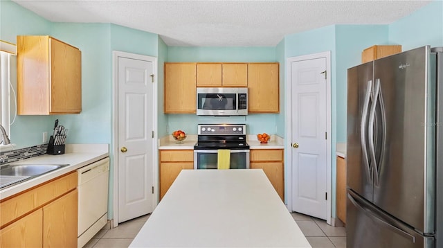 11257 Dacre Ln, Orlando, FL 32824 - kitchen with appliances with stainless steel finishes, light tile patterned floors, light brown cabinets, light countertops, and a textured ceiling