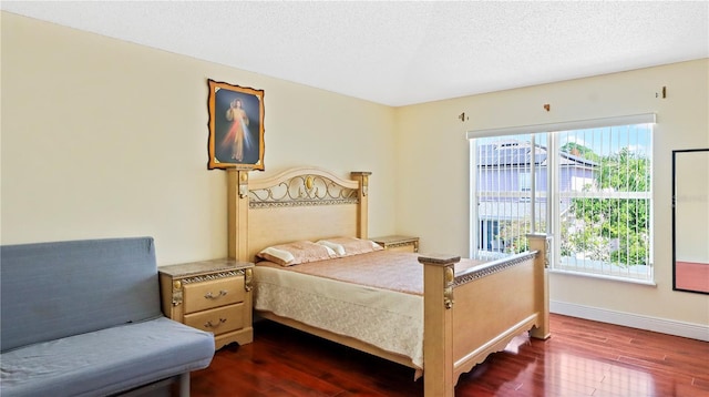 11257 Dacre Ln, Orlando, FL 32824 - bedroom featuring dark wood-style floors, a textured ceiling, and baseboards