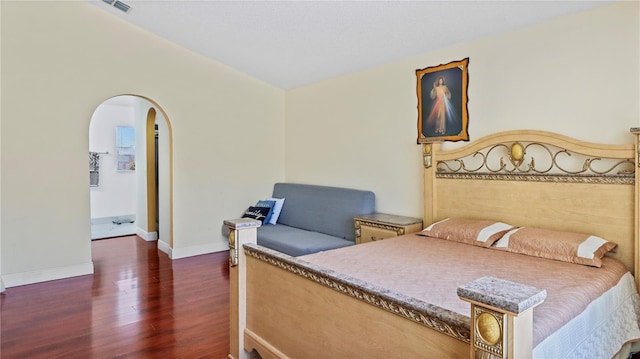 11257 Dacre Ln, Orlando, FL 32824 - bedroom with wood finished floors, arched walkways, and baseboards