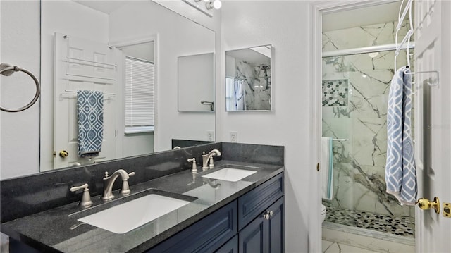 11257 Dacre Ln, Orlando, FL 32824 - full bath featuring marble look tile flooring, a marble finish shower, double vanity, and toilet