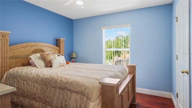 11257 Dacre Ln, Orlando, FL 32824 - bedroom featuring baseboards, dark wood-type flooring, and a ceiling fan