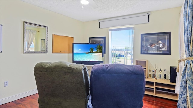 11257 Dacre Ln, Orlando, FL 32824 - living area featuring wood finished floors, ceiling fan, a textured ceiling, and baseboards