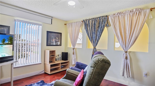 11257 Dacre Ln, Orlando, FL 32824 - living area with wood finished floors, plenty of natural light, a textured ceiling, and ceiling fan