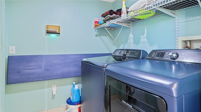 11257 Dacre Ln, Orlando, FL 32824 - washroom with washer and clothes dryer and tile patterned flooring